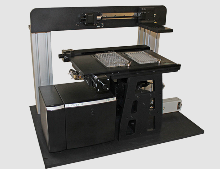 A customized microscope with a gantry axis to allow easy and rapid transfer of samples in well plates.